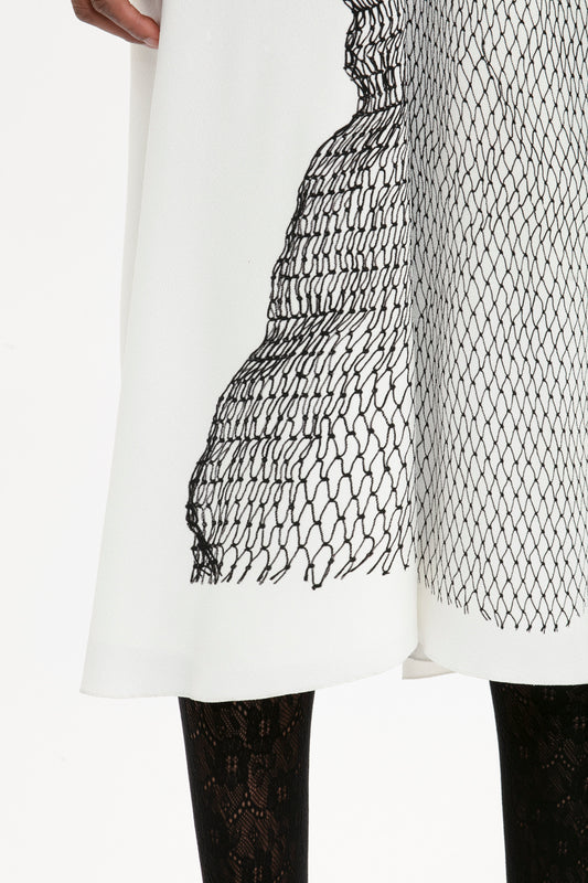 A close-up of an exclusive Victoria Beckham Gathered Waist Midi Dress In White-Black Contorted Net fit-and-flare dress.