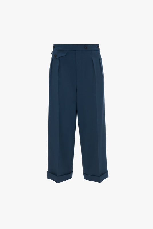 Wide Leg Cropped Trouser In Heritage Blue by Victoria Beckham, with pleated detailing and a buttoned waist tab, crafted from recycled wool, displayed on a white background.