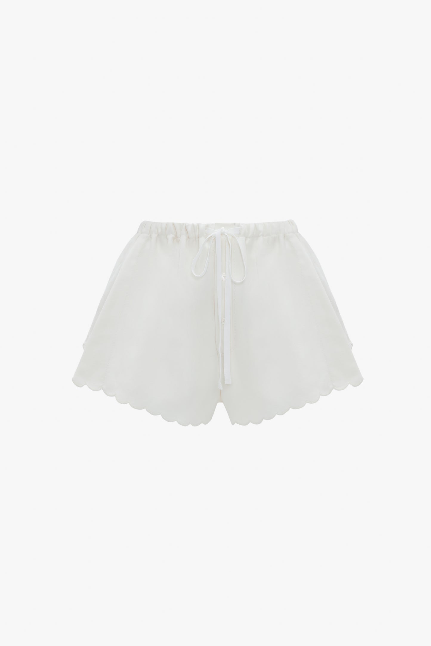 Drawstring Embroidered Mini Short In Antique White by Victoria Beckham, crafted from an antique white linen-cotton blend, feature an elastic waistband and drawstring tie, accented with delicate embroidered detailing. Displayed against a white background.