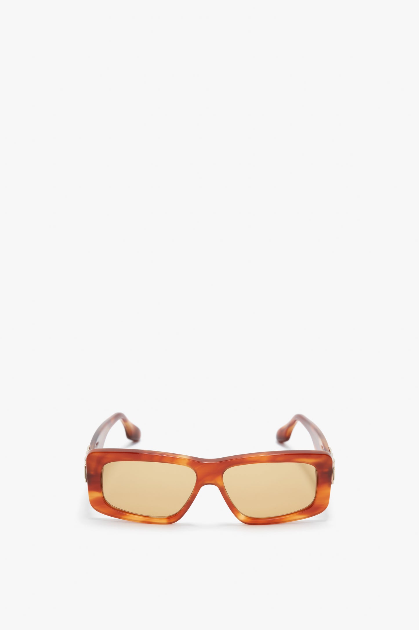 Rectangular, amber-colored sunglasses with light brown lenses and chain detail on the frames, viewed from the front against a plain white background. This stylish pair is known as the Chain Detail Rectangular Frame Sunglasses In Striped Blonde Havana and is part of the Victoria Beckham eyewear collection.