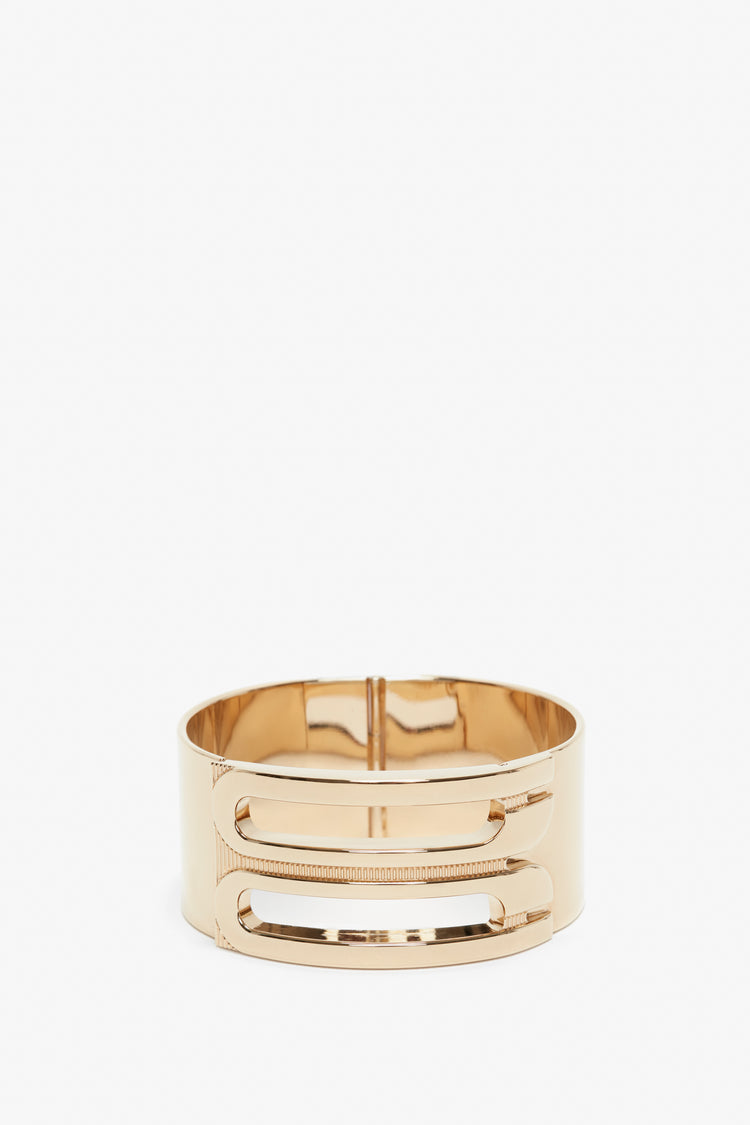 Exclusive Frame Bracelet In Gold by Victoria Beckham, featuring a sleek, modern design with horizontal slots. It is displayed against a plain white background.