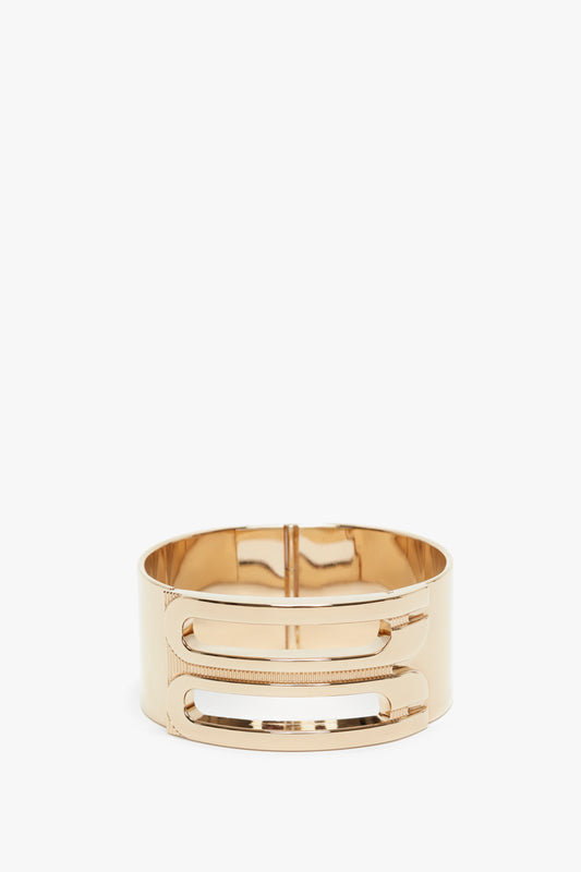 Exclusive Frame Bracelet In Gold by Victoria Beckham, featuring a sleek, modern design with horizontal slots. It is displayed against a plain white background.