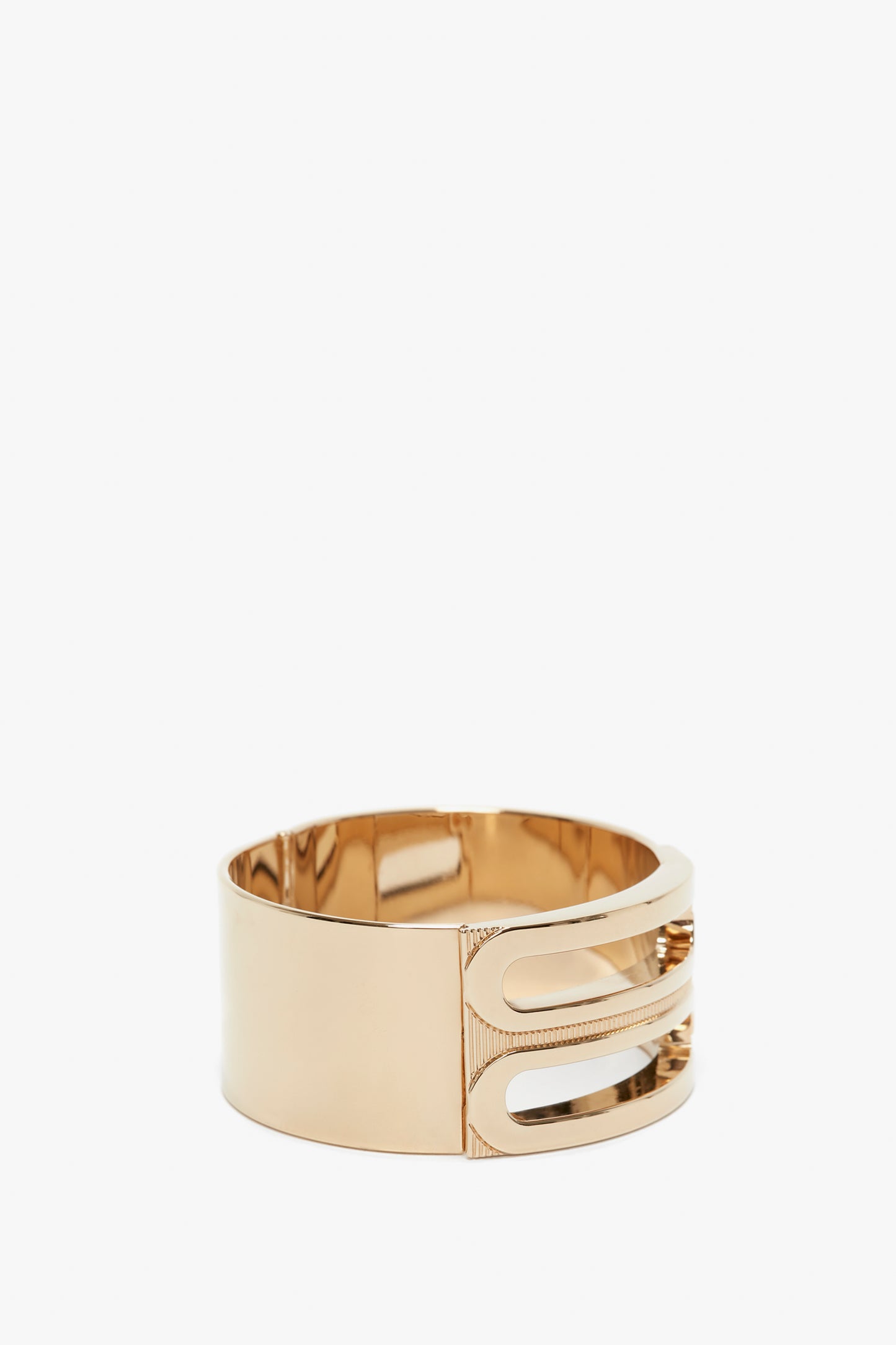 Exclusive Frame Bracelet In Gold by Victoria Beckham, with a sleek design and a clasp detail, isolated on a white background.