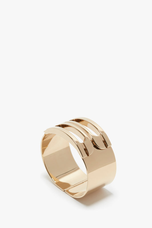 A shiny rose gold-plated brass Exclusive Frame Bracelet In Gold with a smooth surface and sleek design, displayed on a white background by Victoria Beckham.