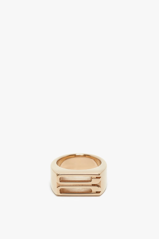 A Exclusive Frame Signet Ring In Gold with a geometric, layered band design, isolated on a white background by Victoria Beckham.