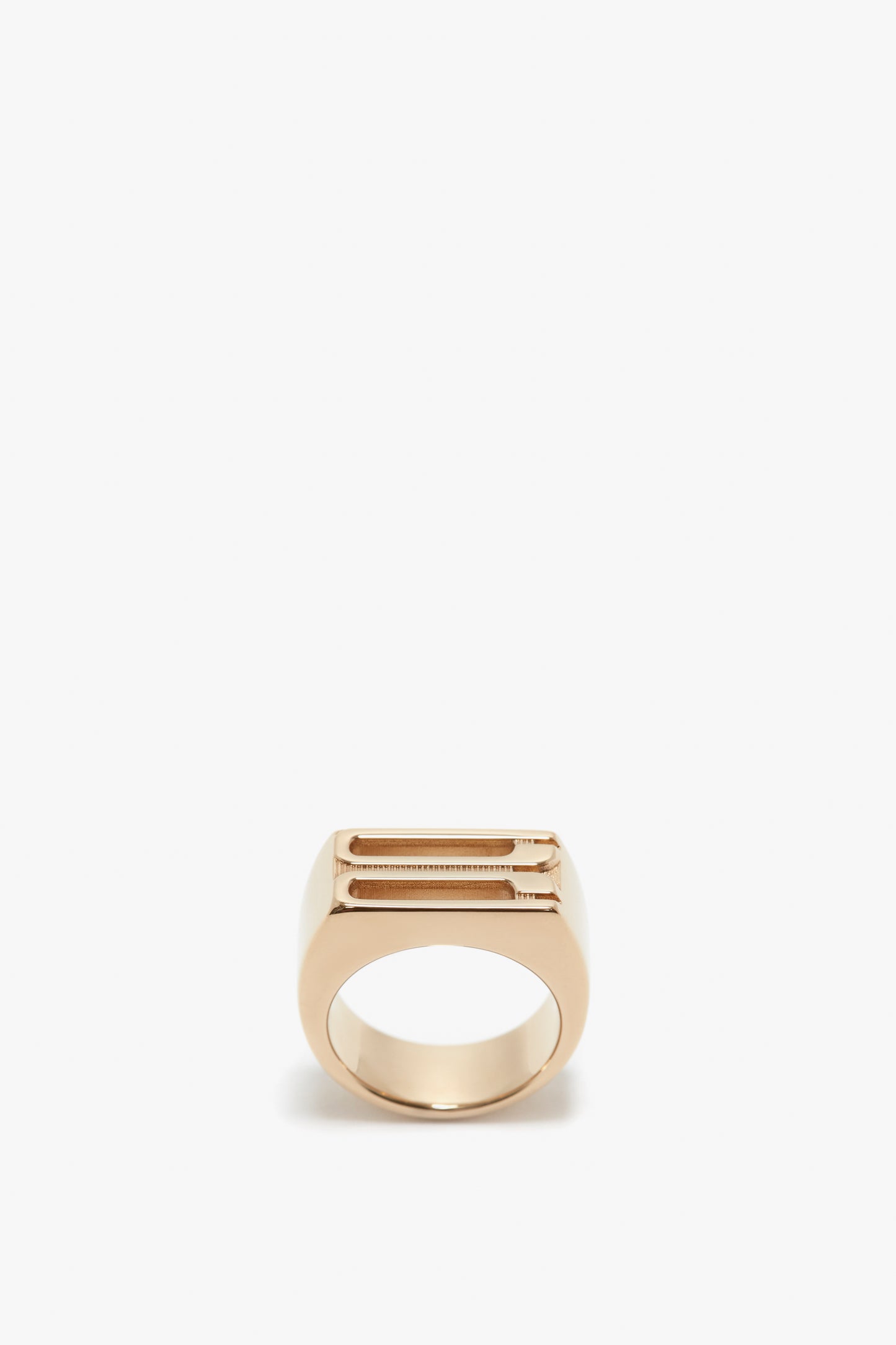 Exclusive Frame Signet Ring In Gold by Victoria Beckham, with a rectangular top plate, isolated on a white background.