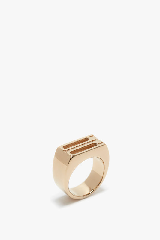 Exclusive Frame Signet Ring In Gold by Victoria Beckham, with a rectangular slot at the top, isolated on a white background.