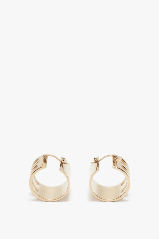A pair of Exclusive Frame Hoop Earrings In Gold by Victoria Beckham with a latch back, isolated on a white background.