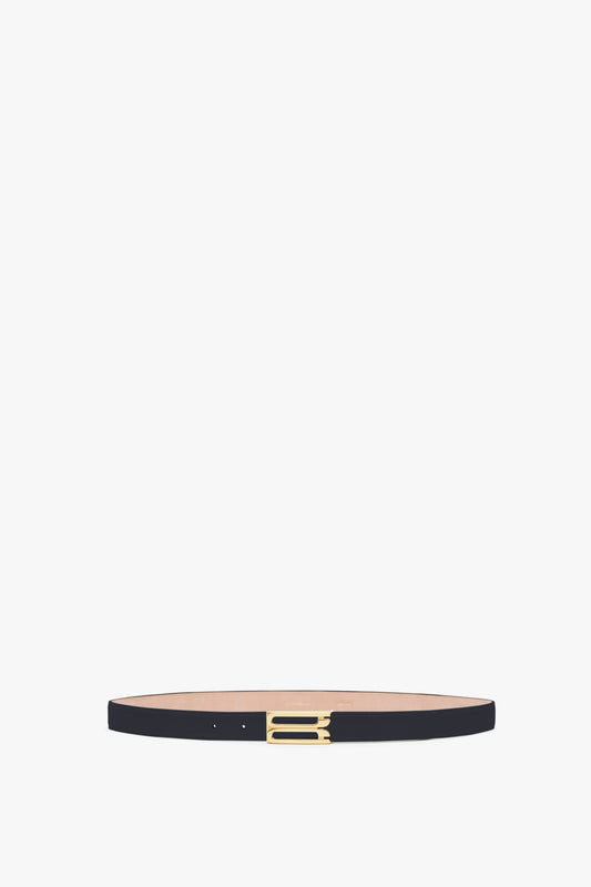 A slim black calf leather belt with a small, rectangular gold buckle, displayed against a plain light gray background.