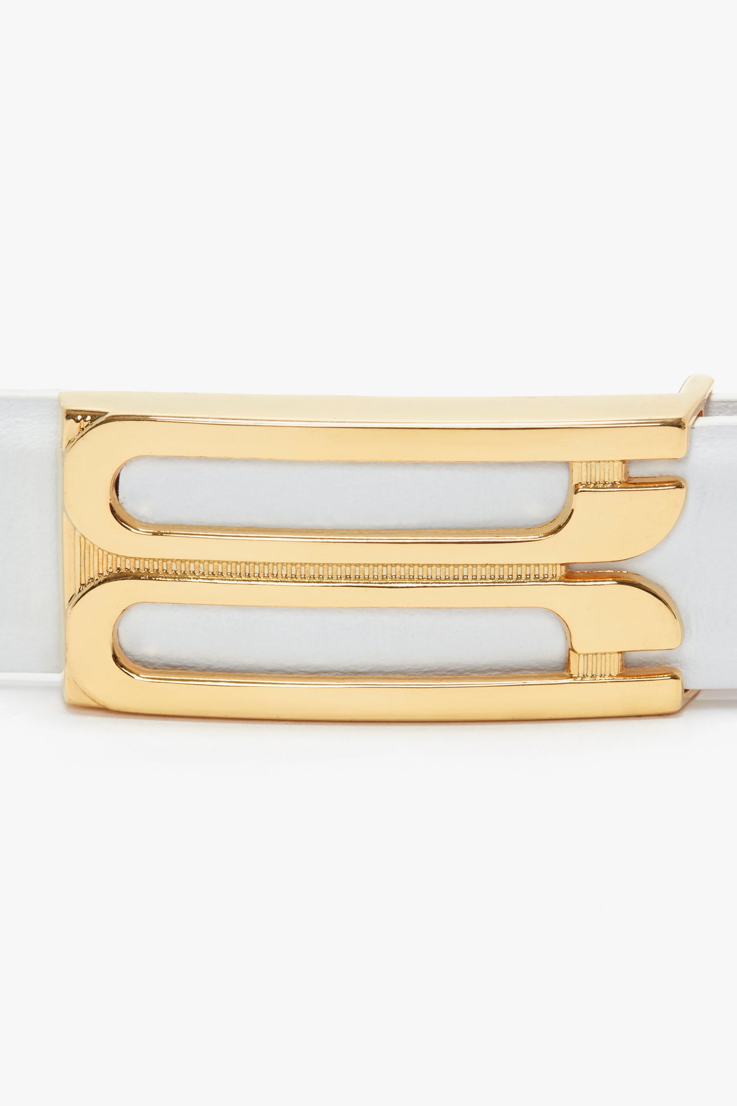 Gold buckle close-up on a Victoria Beckham Exclusive Frame Belt in White Leather, showing a sleek design with two elongated slots.