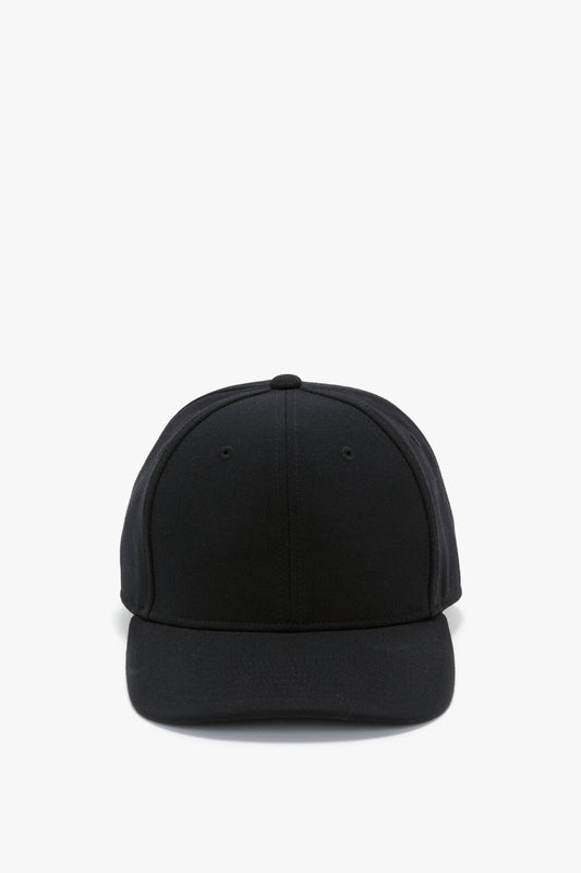 Front view of a plain black Victoria Beckham Exclusive Logo Cap isolated on a white background.