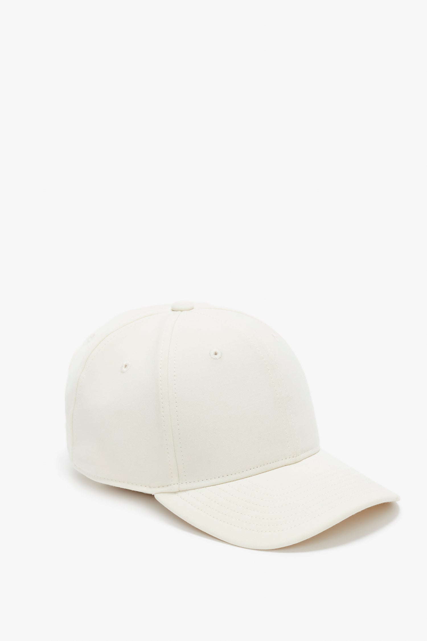 A Victoria Beckham Logo Cap in Antique White with a curved brim and an adjustable snap, shown against a white background.