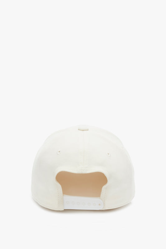 Rear view of a plain white Victoria Beckham Logo Cap In Antique White with an adjustable snap, isolated on a white background.