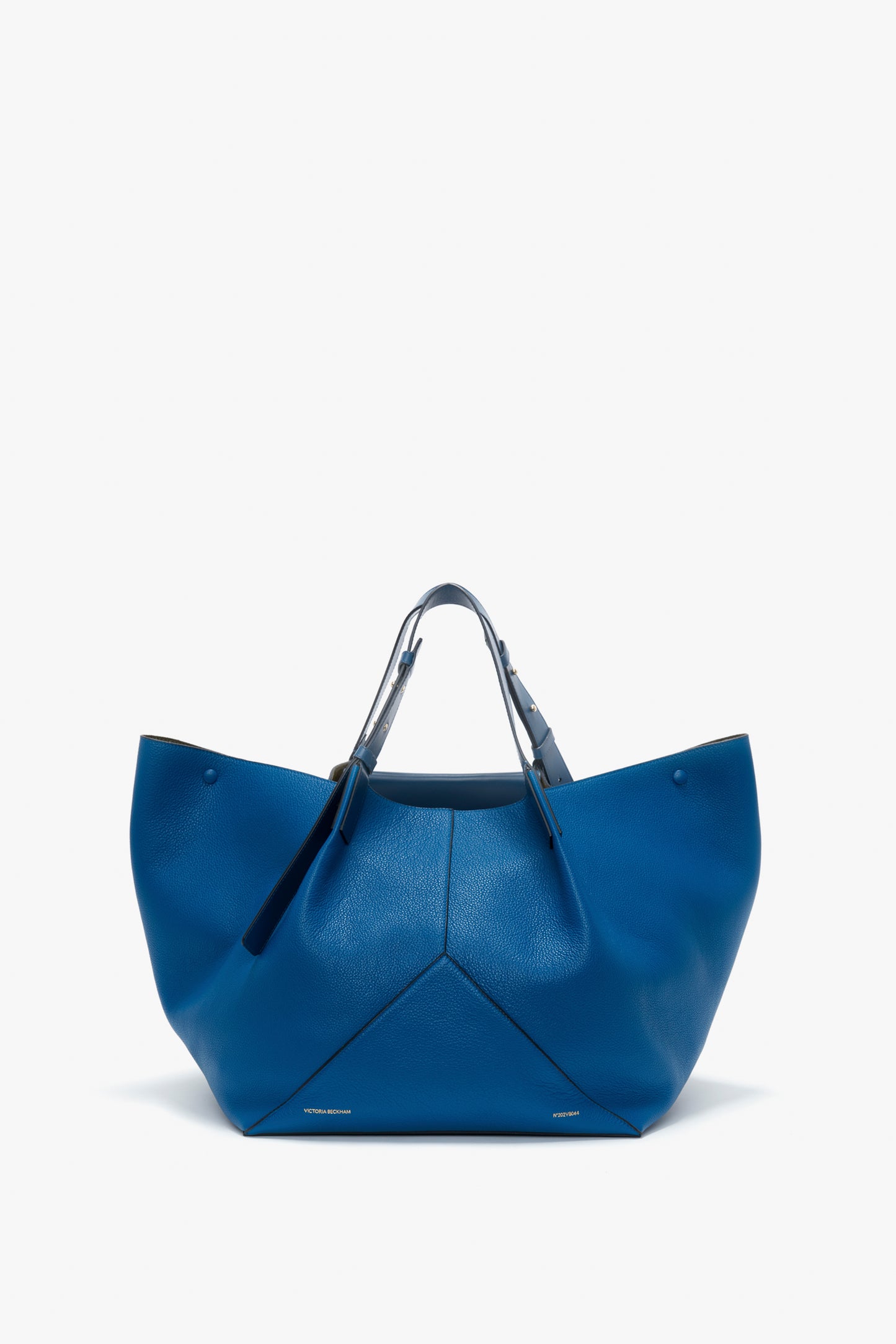 A W11 Medium Tote Bag In Vibrant Blue Leather by Victoria Beckham, featuring a textured leather surface, with two handles and a wide opening.