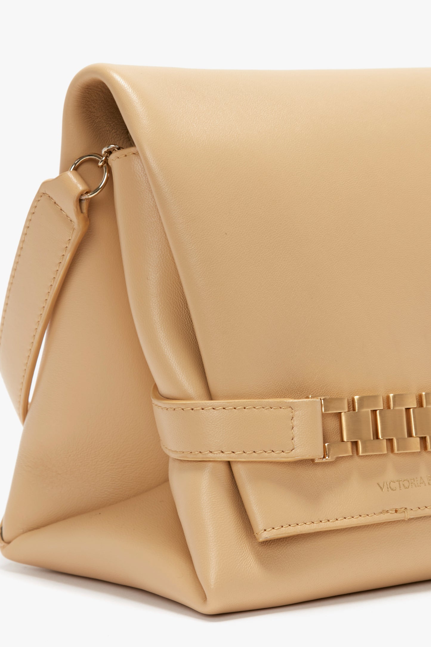 A Chain Pouch Bag With Strap In Sesame Leather by Victoria Beckham, featuring a strap, woven detailing on its front, and a versatile gold chain detail.