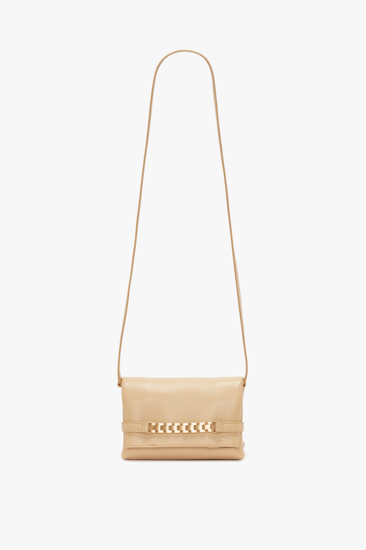 A small beige crossbody bag with a long strap and a gold chain detail on the front, reminiscent of a Mini Pouch With Long Strap In Sesame Leather by Victoria Beckham.