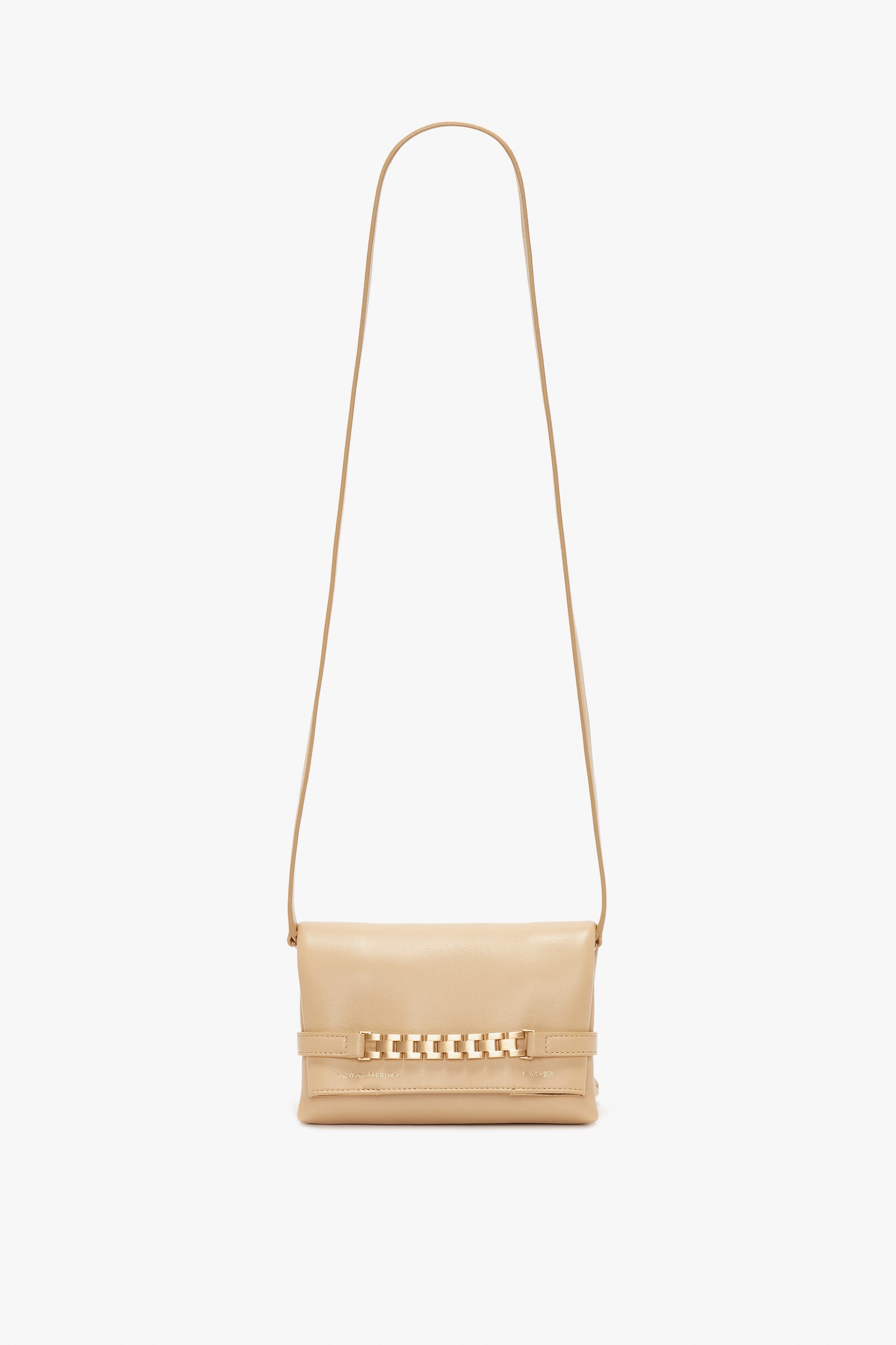 A small beige crossbody bag with a long strap and a gold chain detail on the front, reminiscent of a Mini Pouch With Long Strap In Sesame Leather by Victoria Beckham.