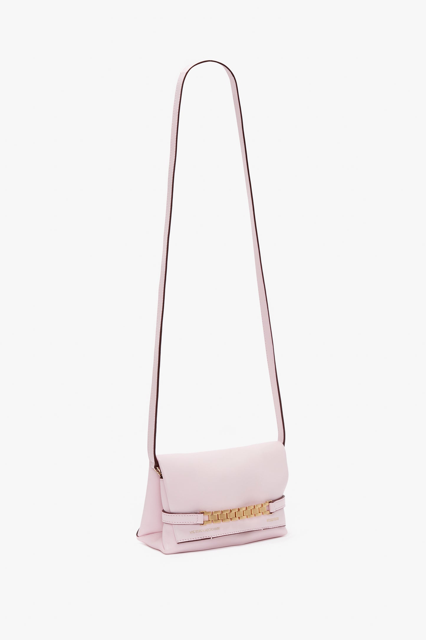A Victoria Beckham Mini Chain Pouch Bag With Long Strap In Orchid Leather, featuring a rectangular body and a gold-tone clasp detail on the front.