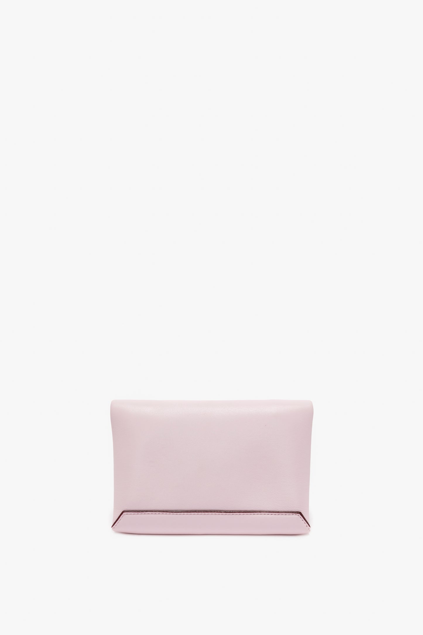 A rectangular, pale pink Mini Chain Pouch Bag With Long Strap In Orchid Leather by Victoria Beckham with a minimalist design is centered against a white background, subtly resembling a chic mini pouch.