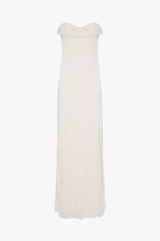 A plain white Exclusive Floor-Length Corset Detail Gown In Ivory with a crease-effect skirt, displayed against a white background by Victoria Beckham.