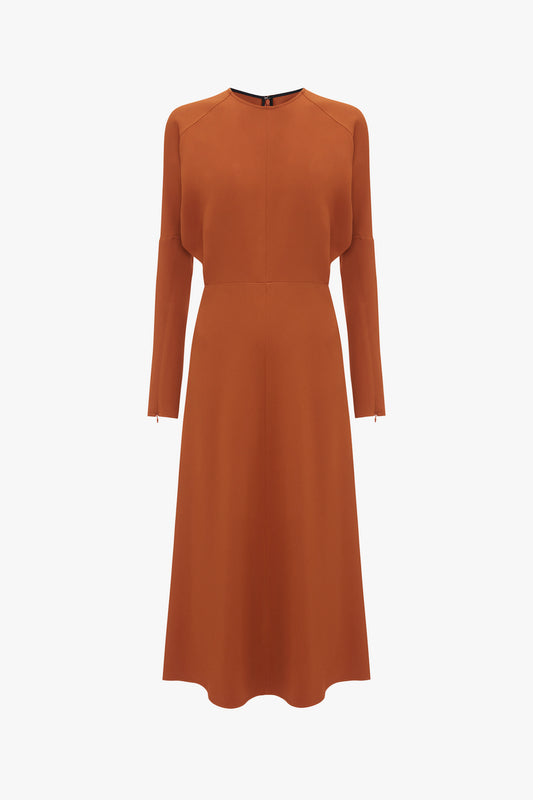 An elegant long-sleeve Dolman Midi Dress In Russet by Victoria Beckham with a fitted waist and a flared skirt, isolated on a white background.