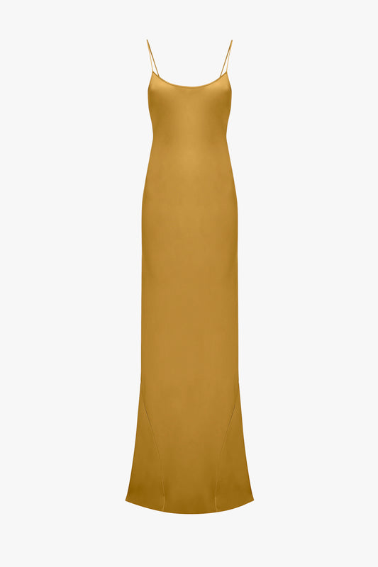 A Victoria Beckham Low Back Cami Floor-Length Dress In Harvest Gold with thin spaghetti straps and a subtle flare at the hem.