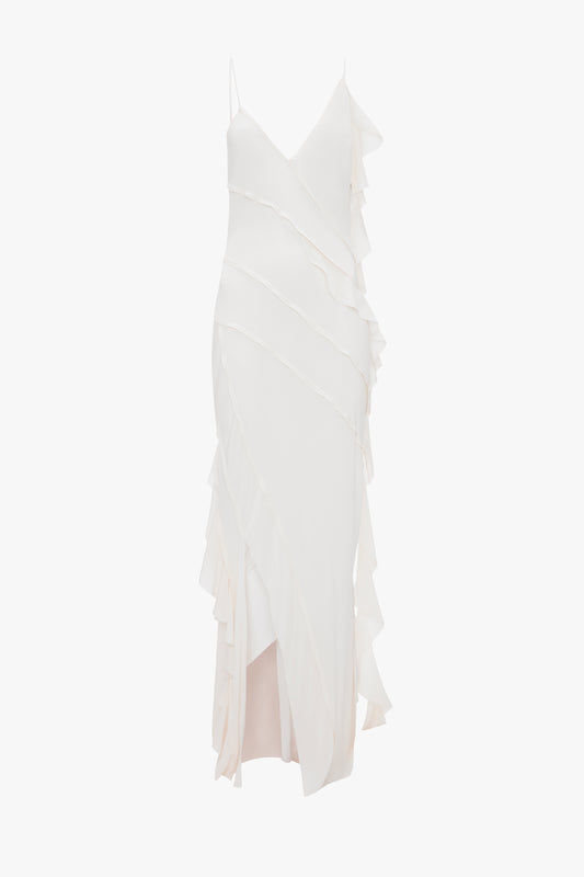 A Victoria Beckham Exclusive Asymmetric Bias Frill Dress In Ivory with layered ruffle detailing and lace accents, displayed against a white background.