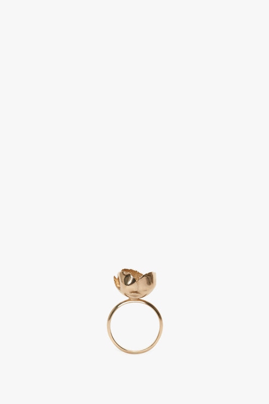Exclusive Camellia Flower Ring In Gold by Victoria Beckham, with a rose design on top, displayed on a white background.