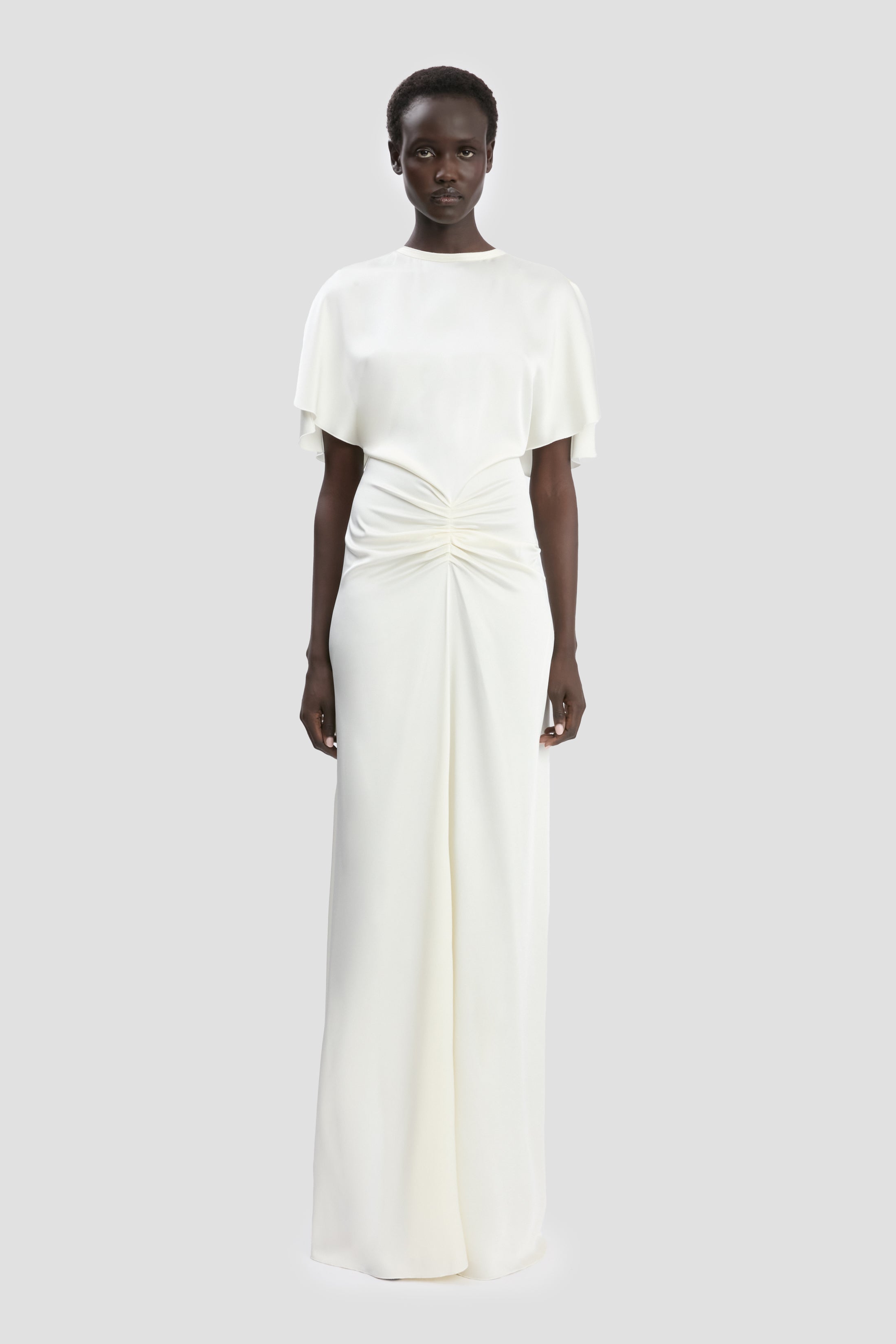 victoria beckham in white dress wears a bridal gown to royal event Halterneck Shoulder straps Pullover style Open twist back Pooled hem Acetate/viscose Dry clean Imported SIZE Victoria Beckham Is Dreamy in