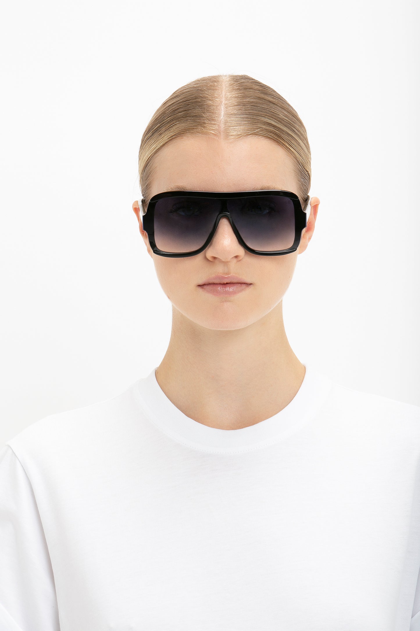 A woman wearing Layered Mask Sunglasses in Black Gradient by Victoria Beckham.