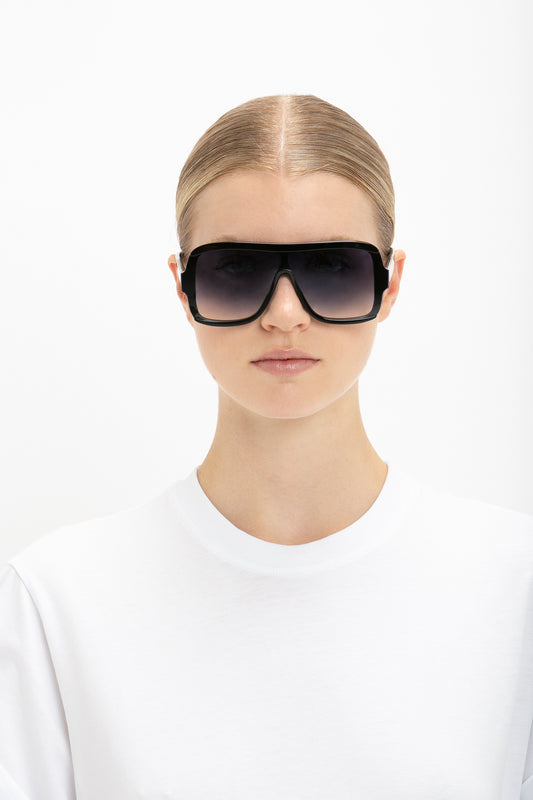 A woman wearing Layered Mask Sunglasses in Black Gradient by Victoria Beckham.