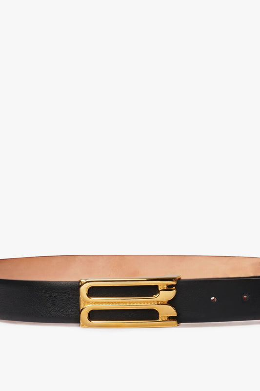 Frame Buckle Belt In Black Leather by Victoria Beckham, isolated on a white background.
