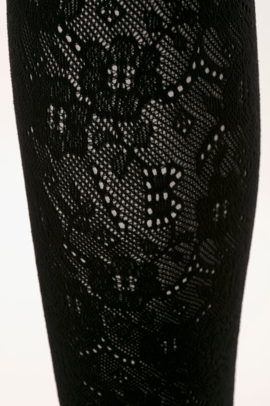 Close-up of Exclusive VB Monogram Lace Tights in Black by Victoria Beckham with intricate floral patterns in seamless construction.