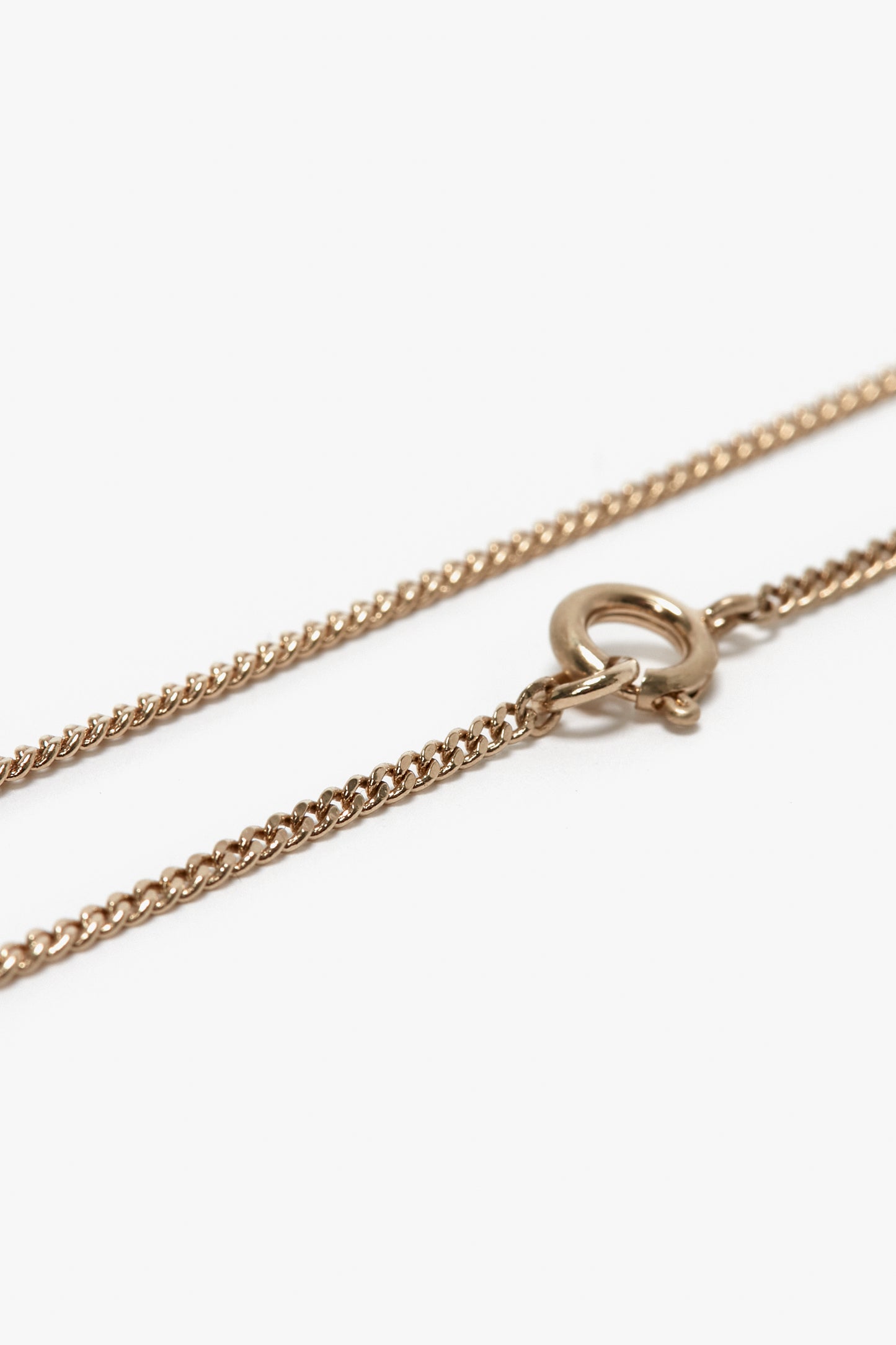 Close-up of the Victoria Beckham Exclusive Long Fine Chain In Gold, made of gold-plated brass with a spring ring clasp, reminiscent of Victoria Beckham's elegant style.