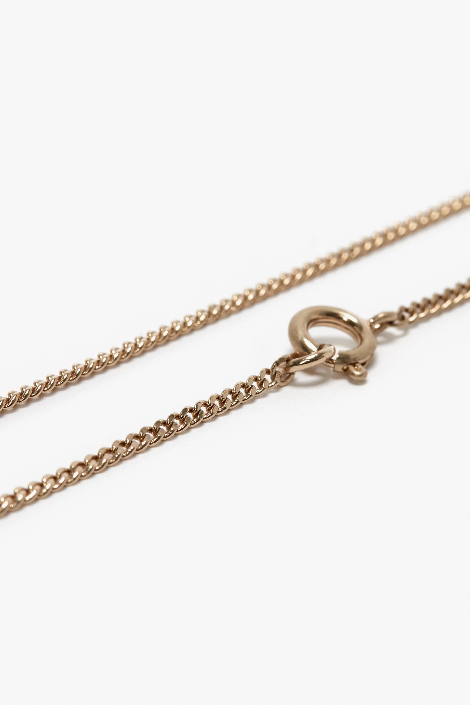 Close-up of the Victoria Beckham Exclusive Long Fine Chain In Gold, made of gold-plated brass with a spring ring clasp, reminiscent of Victoria Beckham's elegant style.