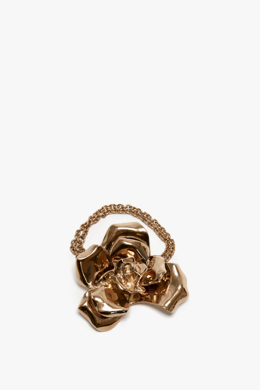 Exclusive Flower Bracelet In Gold by Victoria Beckham with a crystal center and adjustable chain detail, isolated on a white background.