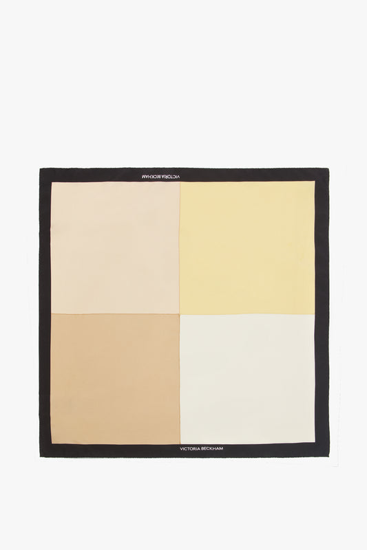 A Victoria Beckham luxurious Colour Block Foulard In Macadamia with a geometric pattern of beige, yellow, and white blocks on a black border.