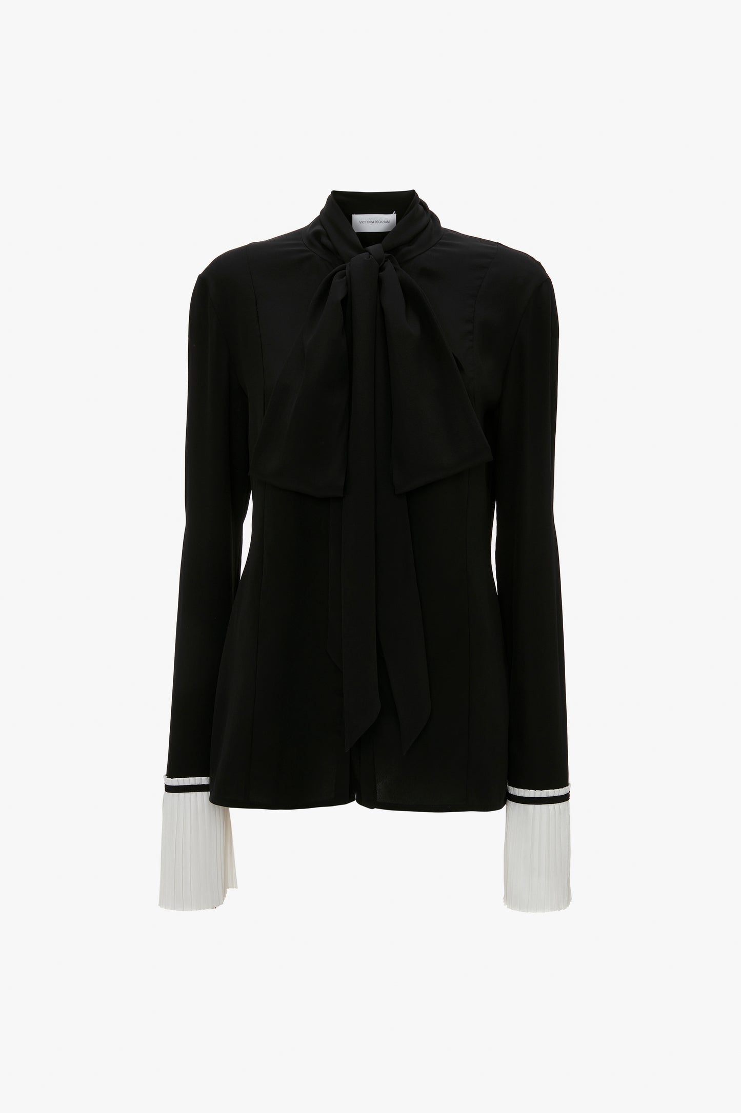 A Pleat Cuff Blouse In Black by Victoria Beckham featuring a large front bow and white knife pleat cuffs for an elegant finish.