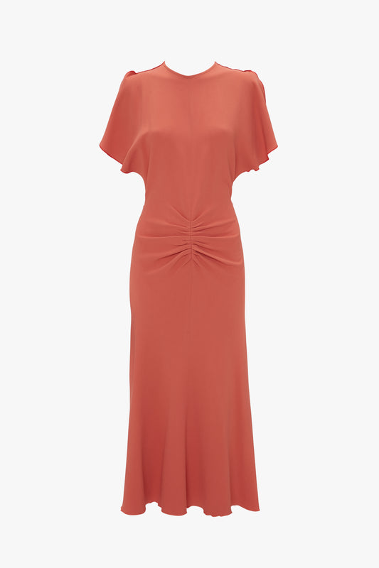 An elegant Victoria Beckham Gathered Waist Midi Dress In Papaya with short sleeves, a gathered front at the waist, and a flared hem, isolated on a white background.