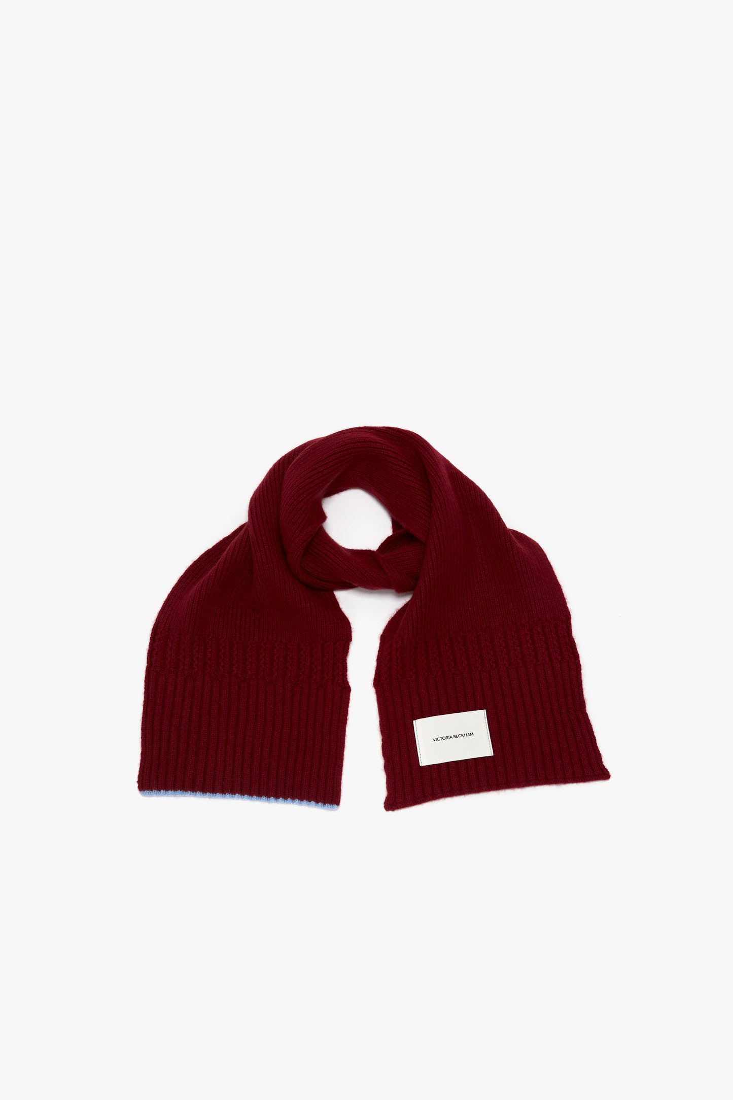 A Victoria Beckham Exclusive Logo Patch Scarf In Burgundy arranged in a loop on a white background, with a visible label.