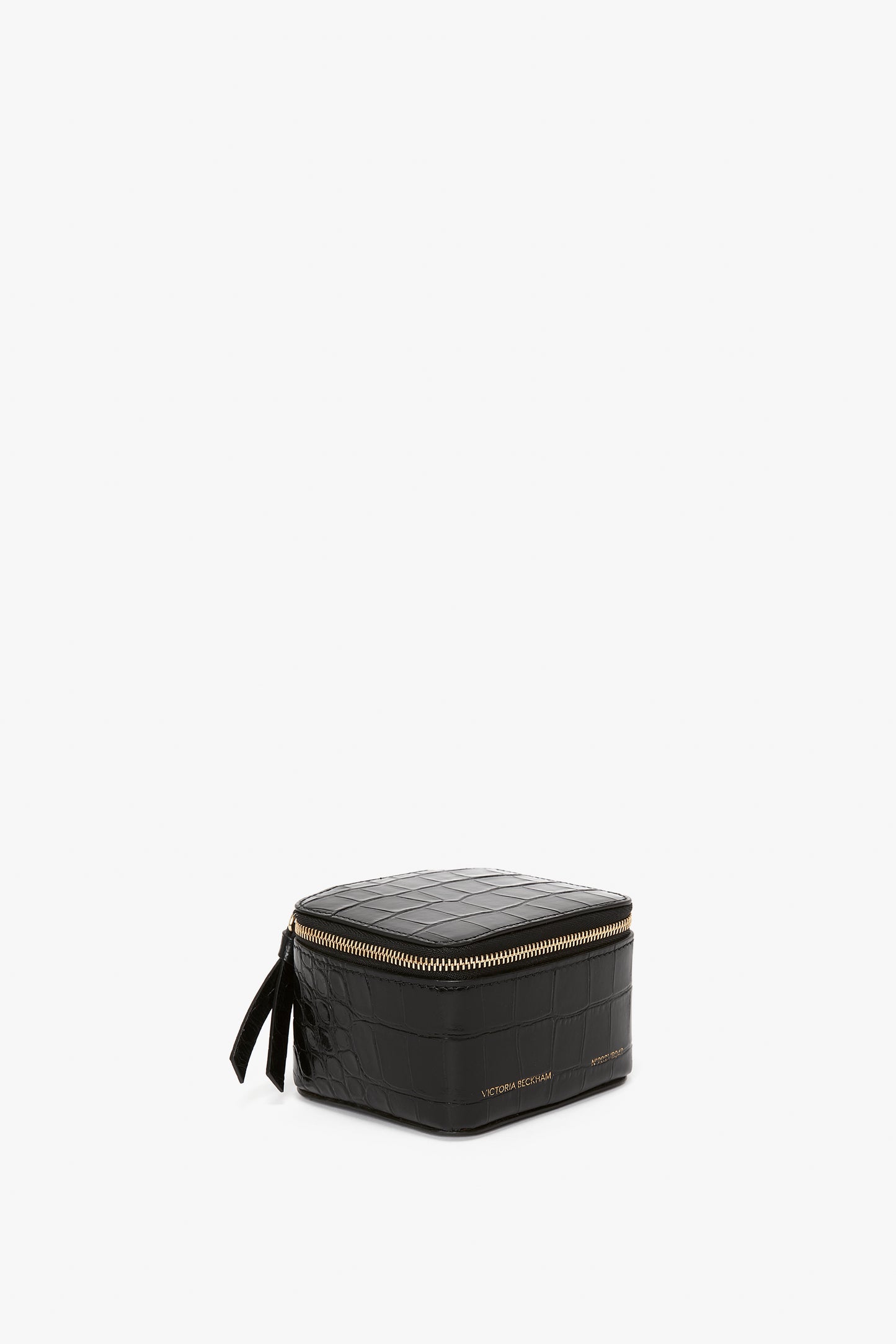 A Victoria Beckham Jewellery Box In Black Croc-Effect Leather with a gold-tone zip closure, isolated on a white background.