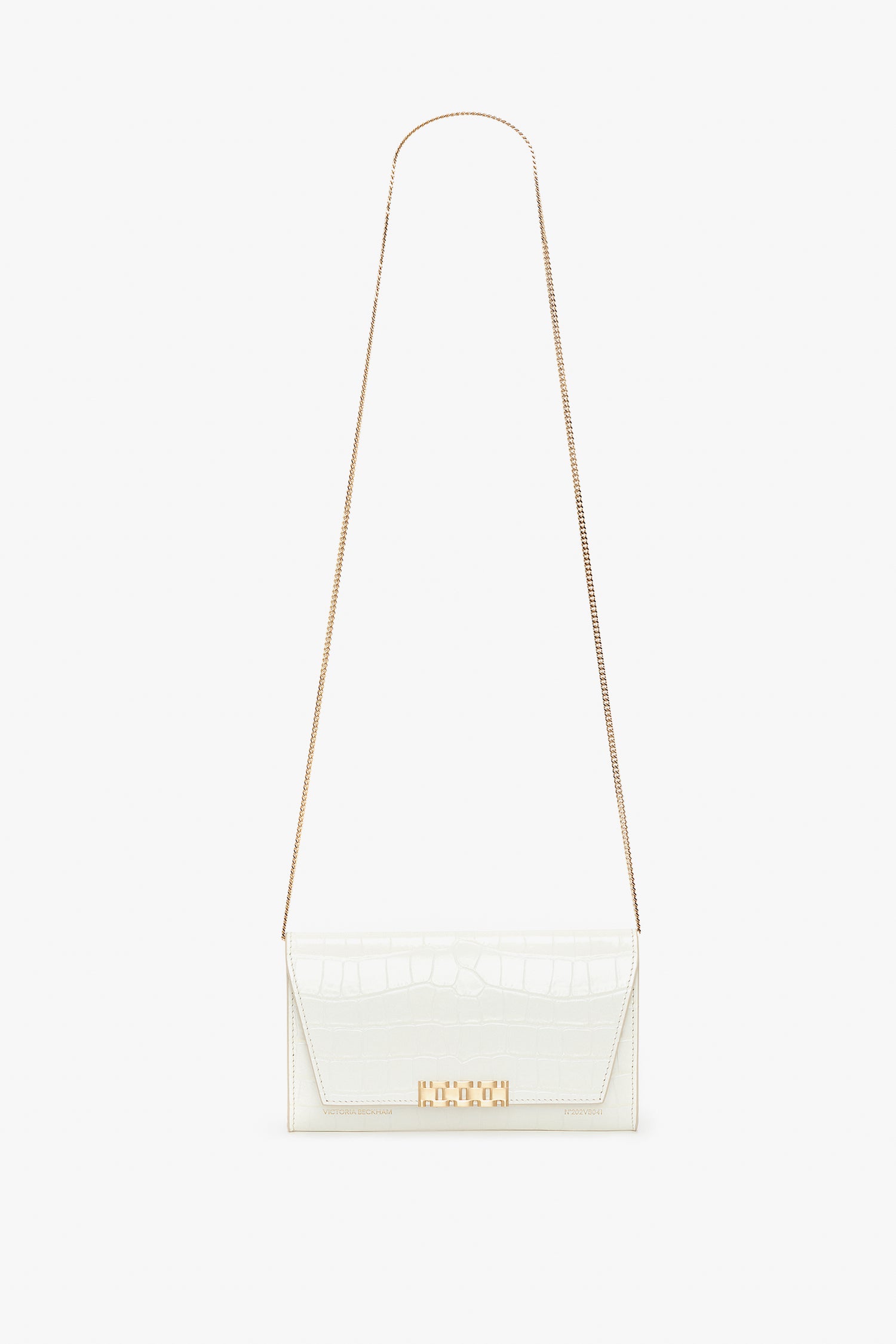 A Victoria Beckham Exclusive Wallet On Chain In Ivory Croc-Effect Leather, featuring a gold chain strap and a gold clasp on the front, is displayed against a white background.