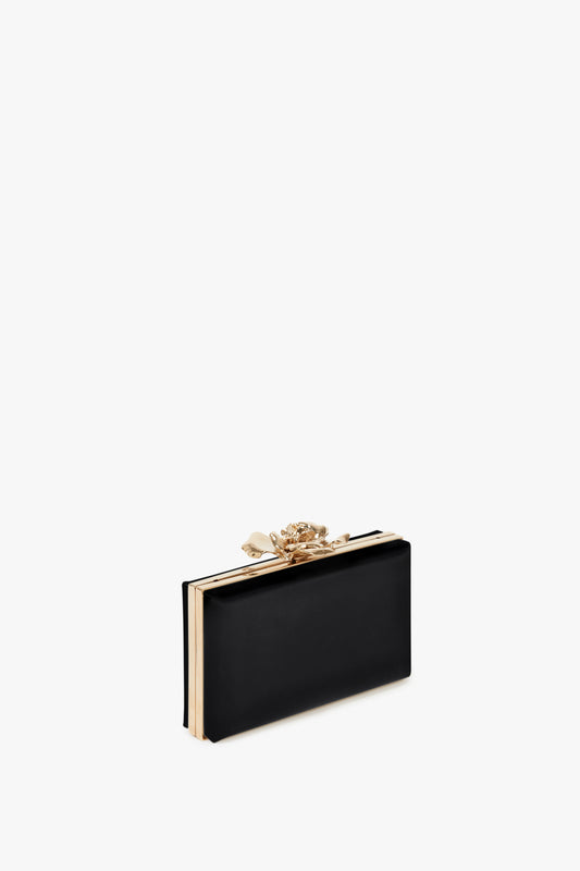 Frame Flower Minaudiere in Black by Victoria Beckham, isolated on a white background.