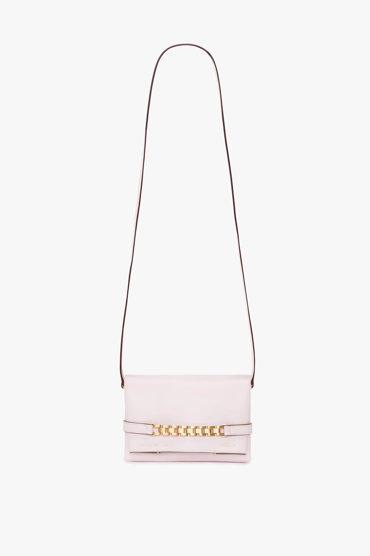 A bubblegum pink crossbody handbag with a straight shoulder strap and gold chain detailing on the front flap, featuring a chic Victoria Beckham Exclusive Mini Chain Pouch Bag With Long Strap In Bubblegum Pink Leather.