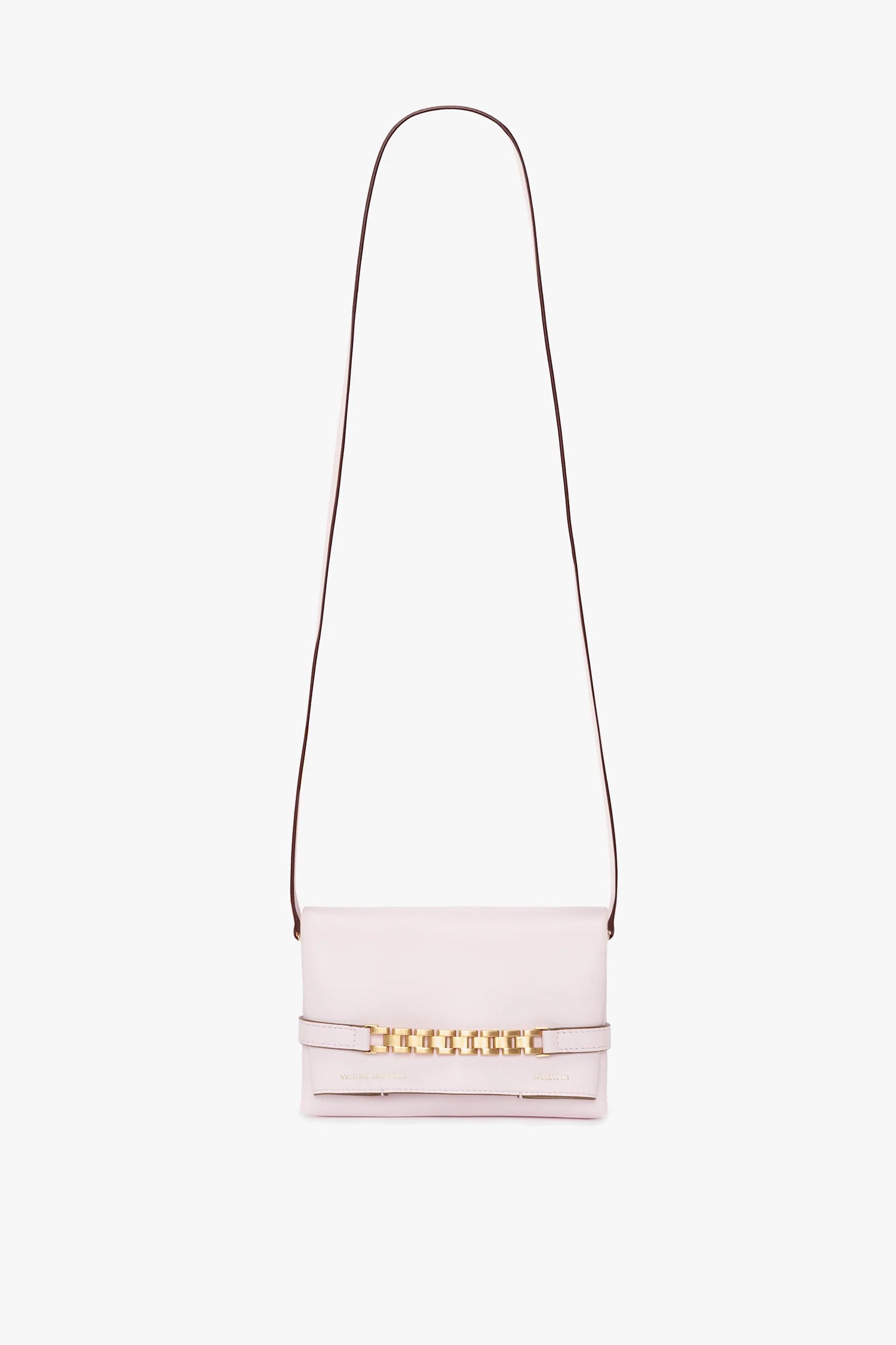 A bubblegum pink crossbody handbag with a straight shoulder strap and gold chain detailing on the front flap, featuring a chic Victoria Beckham Exclusive Mini Chain Pouch Bag With Long Strap In Bubblegum Pink Leather.