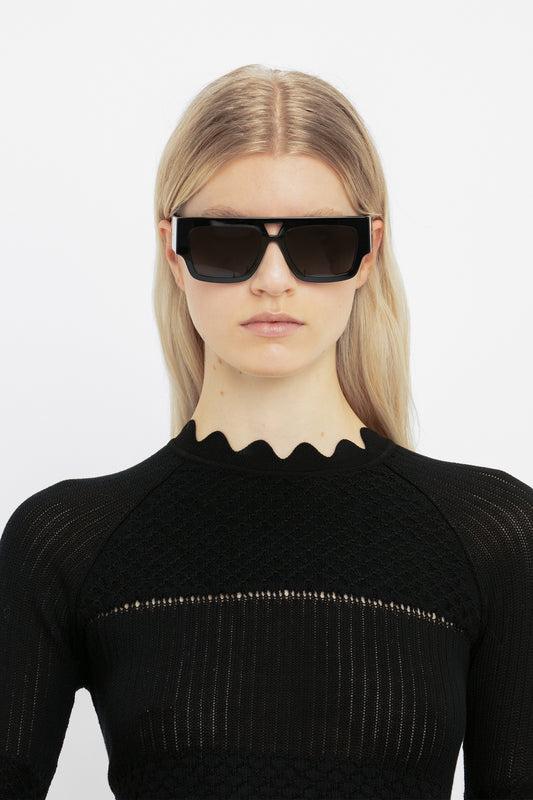 A woman wearing Victoria Beckham V Plaque Frame Sunglasses In Black.