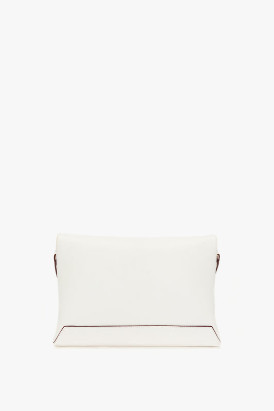 White rectangular chain pouch with strap in white leather by Victoria Beckham, featuring a minimalist design and visible brown stitching at the sides, against a plain white background.