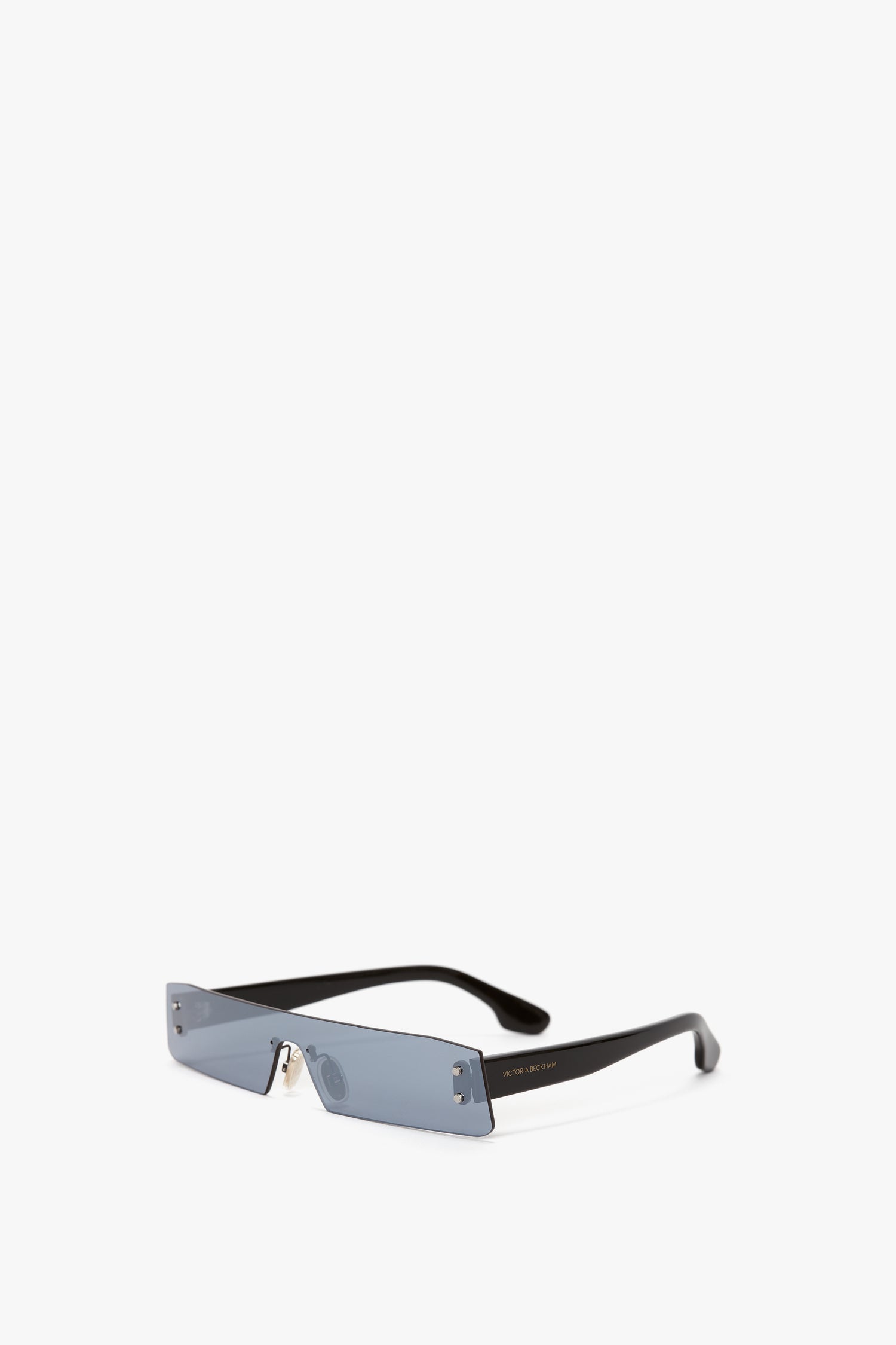 A pair of black, rectangular sunglasses with blue mirror lenses, styled in a modern and minimalist design, reminiscent of the chic style of Victoria Beckham, situated on a plain white background—specifically, the Mini Visor Sunglasses In Blue-Mirror by Victoria Beckham.