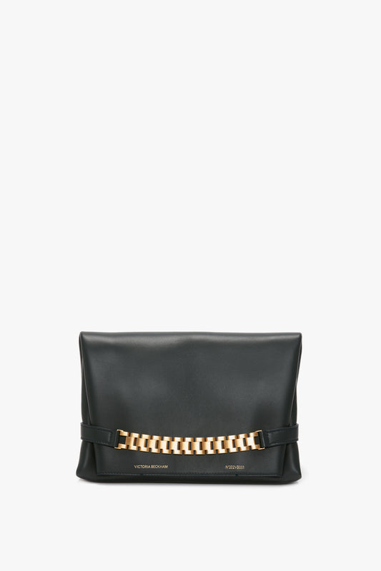 A black Victoria Beckham Chain Pouch Bag in Black Leather with a prominent gold-tone hardware detail across the front.