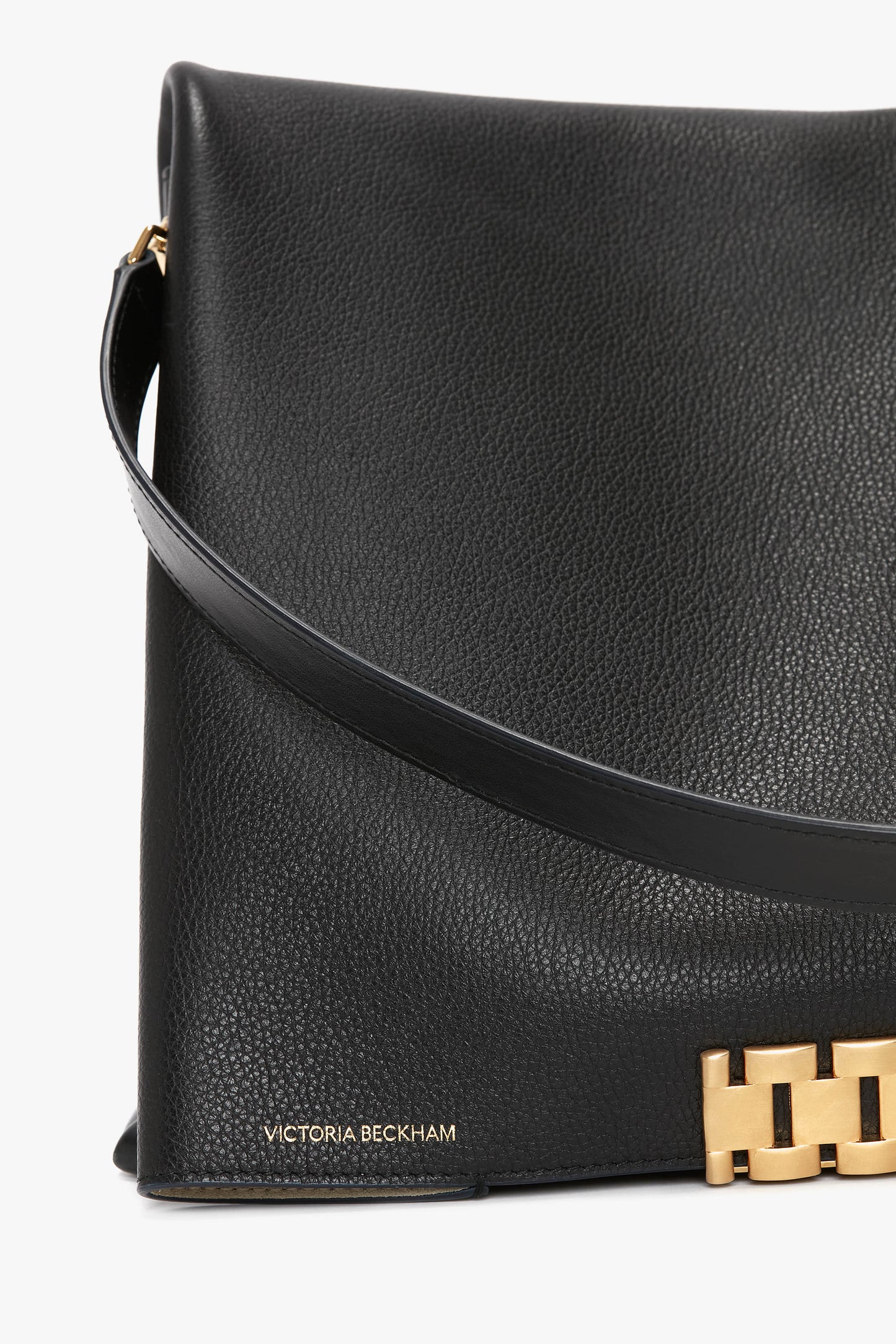 Jumbo Chain Pouch Bag In Black Leather with a gold clasp and the text "Victoria Beckham" in gold lettering on the lower corner, featuring a detachable strap for versatility.